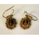 A pair of 9ct gold earrings set with tiger eye, 20