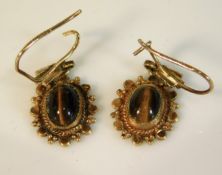 A pair of 9ct gold earrings set with tiger eye, 20