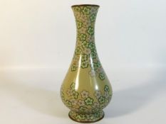 A Japanese cloisonne vase with floral decor on mus