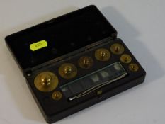 A small bakelite cased weights set by W & J George
