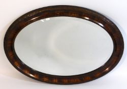 An oval mirror with carved oak leaf decor, 34in wi