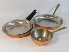 A set of three German Wagner copper pans twinned w