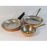 A set of three German Wagner copper pans twinned w