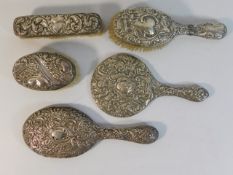 Five pieces of silver backed dressing table items,