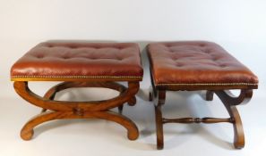 A pair of red leather upholstered foot rests, one