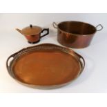 A copper cooking pot with two handles, a copper te