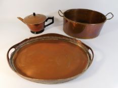 A copper cooking pot with two handles, a copper te