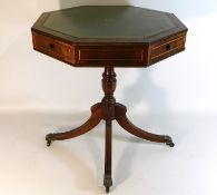 An octagonal drum style table with four drawers &