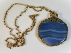 A yellow metal chain & blue agate pendant, chain 7