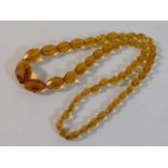 An amber faceted necklace, 24in long