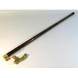 A gents three piece walking cane with brass handle