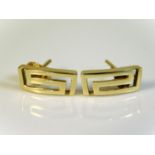 A pair of 10ct gold earrings with Greek style patt