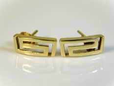 A pair of 10ct gold earrings with Greek style patt