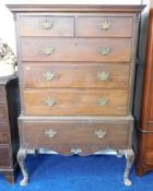 An antique two piece mahogany chest with brass fit