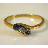 An 18ct gold crossover ring set with platinum mounted sapphire & diamond lacking one other stone, 2.