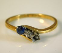 An 18ct gold crossover ring set with platinum mounted sapphire & diamond lacking one other stone, 2.