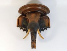 A carved wooden elephant shelf, 13.25in tall x 12i