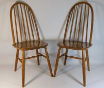 A pair of Ercol style elm dining chairs, unmarked,