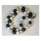 A set of three colour cultured pearls with silver