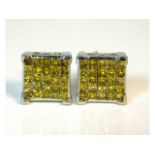 A pair of silver earrings set with 1.5ct of yellow