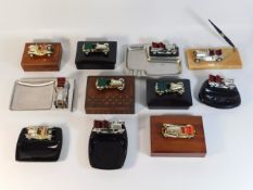 A selection of mounted vintage car ashtrays, boxes & pen holders, including Lesney