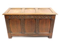 A vintage oak coffer with carved decor with useful