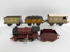 An LMS tin plate clockwork O gauge Hornby type 101 engine, tender & wagons including Meccano, Basset