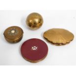 A brass globe compact & three other compacts inclu