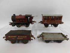 An LMS tin plate clockwork O gauge Hornby engine, tender & wagons