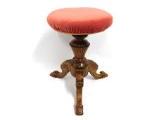 A carved revolving piano stool, 19in high