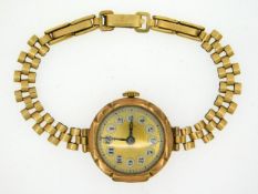 A ladies 9ct gold cased watch with rolled gold str