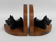 A pair of art deco styled oak bookends with Scotti