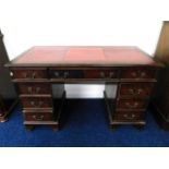 A three piece pedestal desk with red leather style