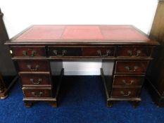 A three piece pedestal desk with red leather style