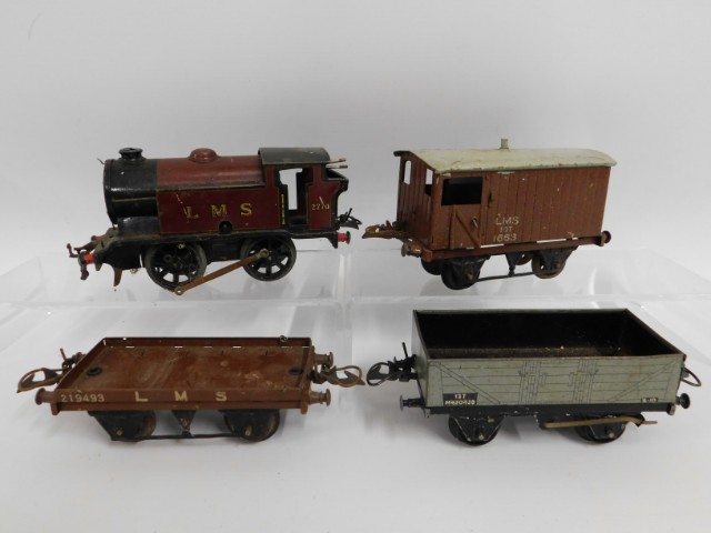 An LMS tin plate clockwork O gauge Hornby engine, tender & wagons