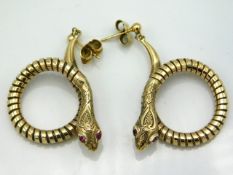 A pair of 9ct gold snake earrings set with ruby eyes, 40mm drop, 9.7g, with Rocks & Co. box