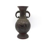 A Chinese relief bronze vase with figures & bats as decor, 10in tall