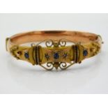 An antique 9ct rose & yellow gold bangle set with sapphire & diamond, internal measurement 59mm diam