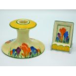 A Clarice Cliff Bizarre crocus design candle holder, 3in high x 4.5in across base, twinned with a Cl