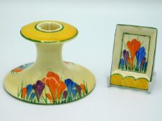 A Clarice Cliff Bizarre crocus design candle holder, 3in high x 4.5in across base, twinned with a Cl