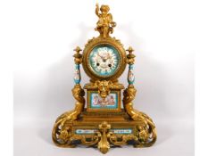 A 19thC. ormolu French clock with figurative decor & Sevres style panels with jewelling, with key. M