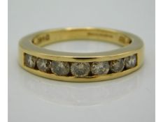 An 18ct gold half eternity ring set with seven diamonds of approx. 1ct, size O/P, 5.6g