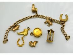 A quantity of 9ct & unmarked gold charms including egg timers & drum twinned with 9ct gold bracelet