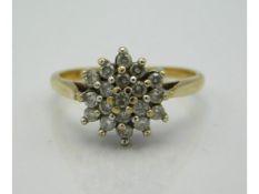 A 9ct gold cluster ring set with approx. 0.28ct small diamonds, 2.5g, size P