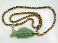 A 9ct gold rope chain with Chinese jade fish pendant, fish measures 35mm wide, necklace 14in long, g