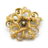 A gold brooch with central pearl & enamelled decor & steel pin, tests electronically as 14ct, 2.7g,