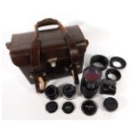 A leather camera accessory case with Canon FD 50mm lens, Hoya HMC 24mm lens, Vivitar series 1 70-210