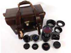 A leather camera accessory case with Canon FD 50mm lens, Hoya HMC 24mm lens, Vivitar series 1 70-210