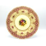 A Royal Worcester porcelain plate with hand painted floral centre signed by John Freeman, 10.25in di