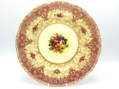 A Royal Worcester porcelain plate with hand painted floral centre signed by John Freeman, 10.25in di